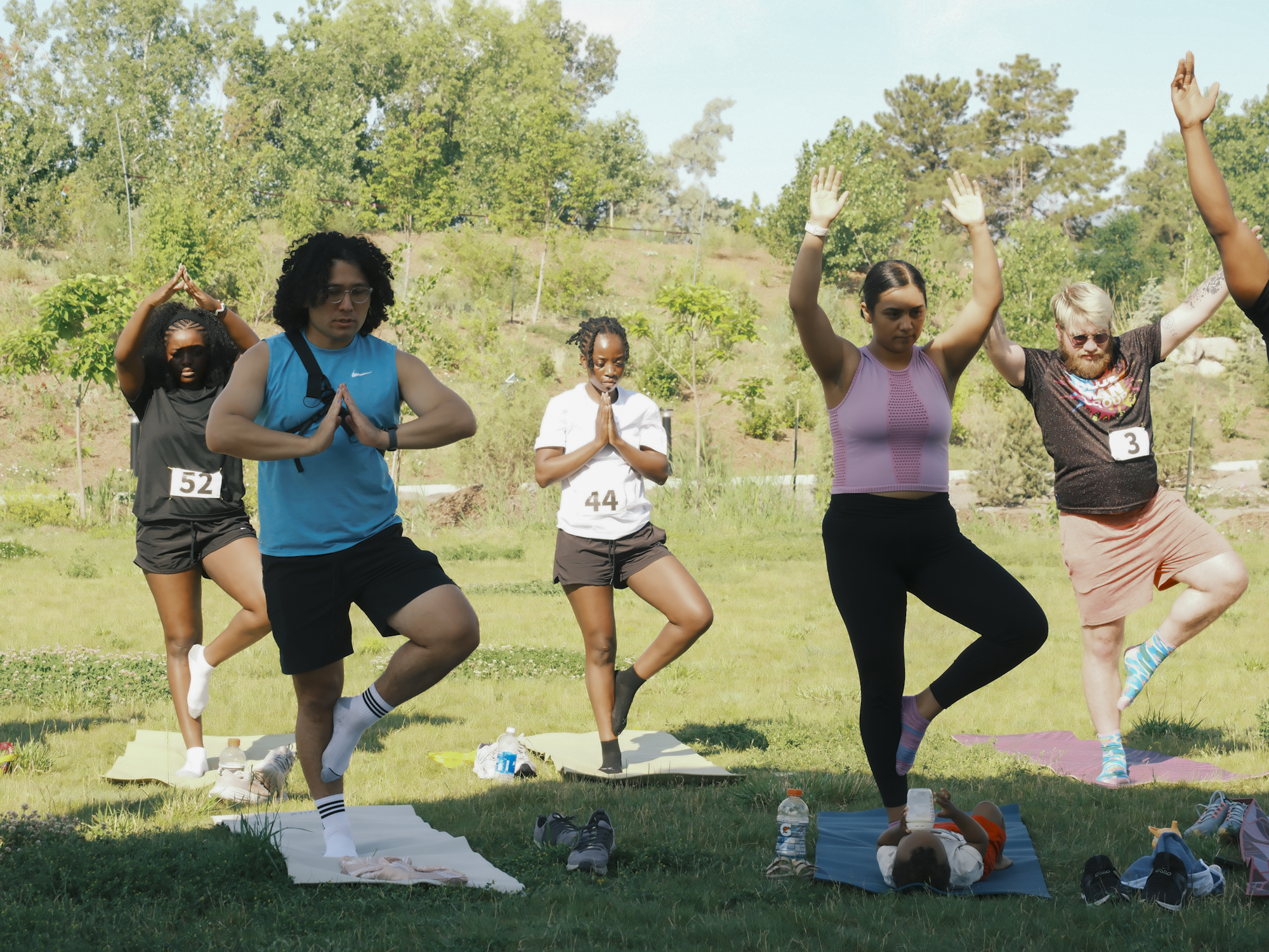 Participants practicing yoga together outdoors after the run.