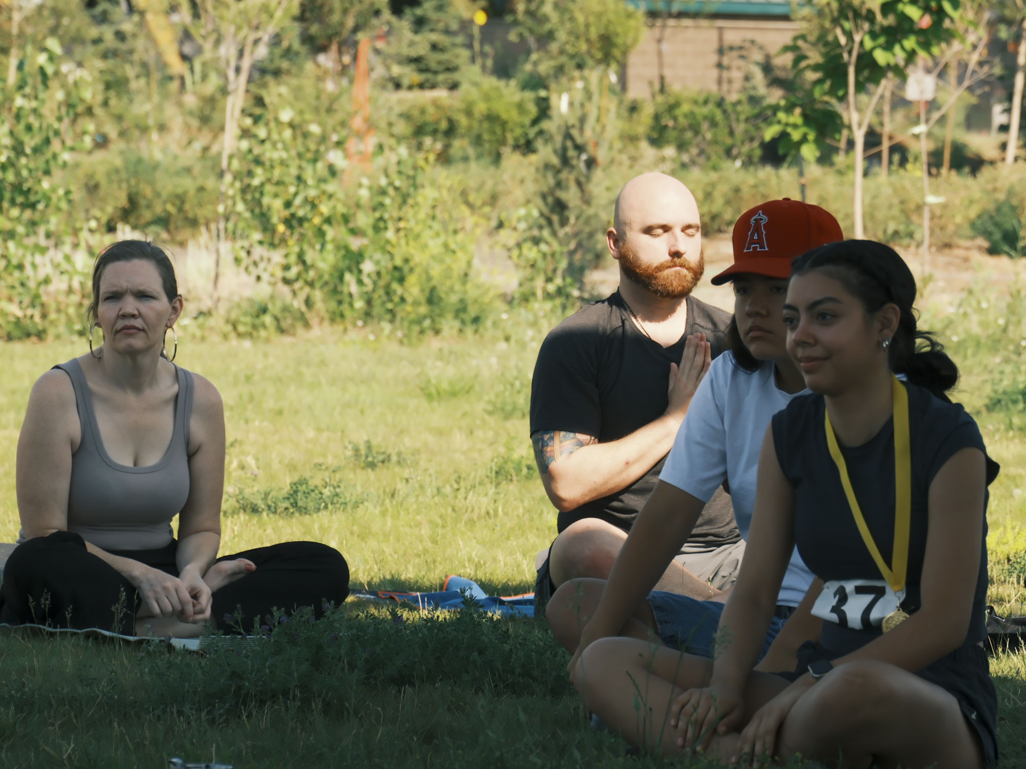 Participants sitting together on the grass during the celebration.